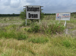 A rear piece of undeveloped land off I-35 between Austin and San Antonio. A developer's dream indeed.