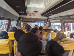 A bus in Antananarivo carries several riders.