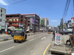 A road in Lagos, where a three-wheeled vehicle passes through.