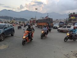 An unsignaled intersection in Kathmandu, Nepal. Motorbikes pass in front of larger vehicles 
