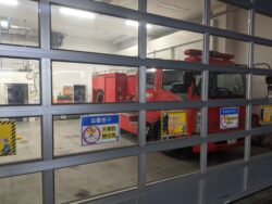 A small fire truck in a garage in Tokyo.