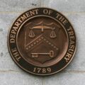 The Treasury Department logo on a wall.