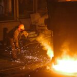 Man in Helmet and Mask Welding Steel, tariffs