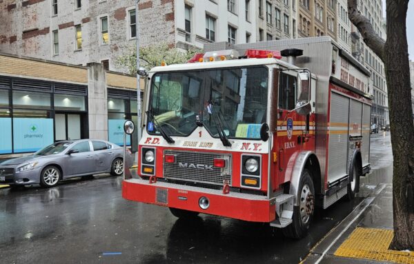 A smaller firetruck on a city street.
