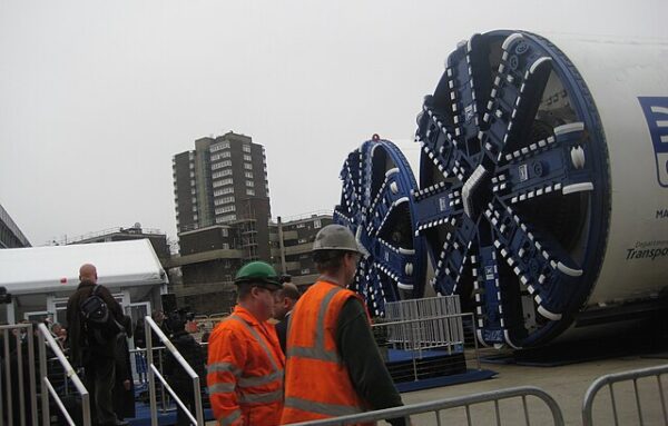 Two tunnel boring machines with workers nearby